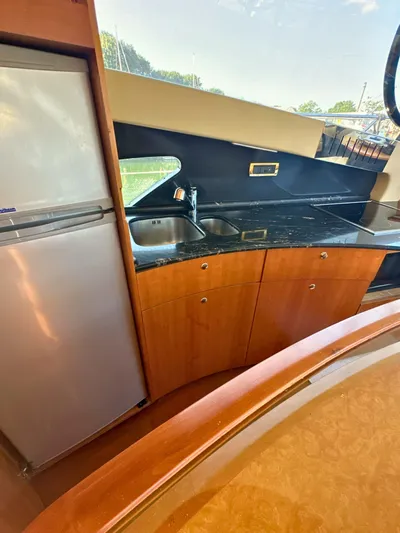 Andiamo Yacht Photos Pics Luxurious kitchen interior of 2010 Azimut 55E yacht with modern appliances and sleek design.