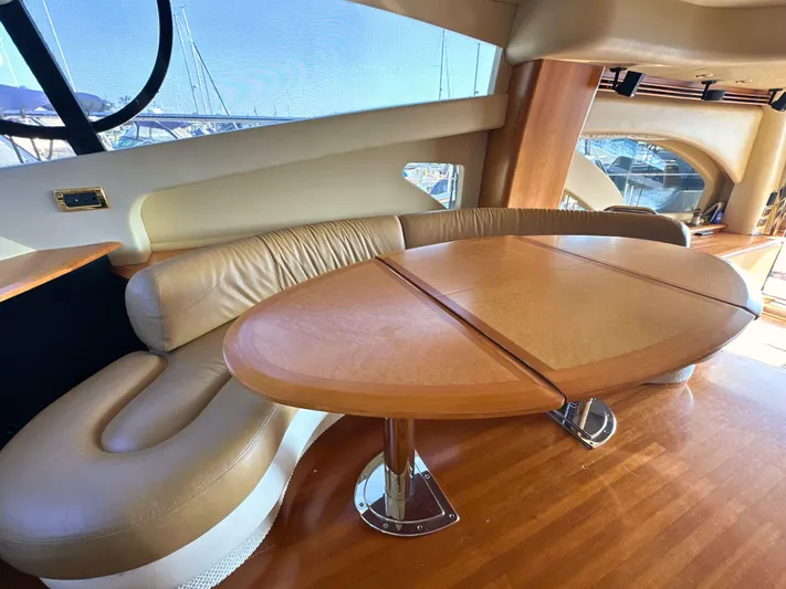 Andiamo Yacht Photos Pics Luxurious interior of 2010 Azimut 55E yacht with elegant leather seating and wooden table.