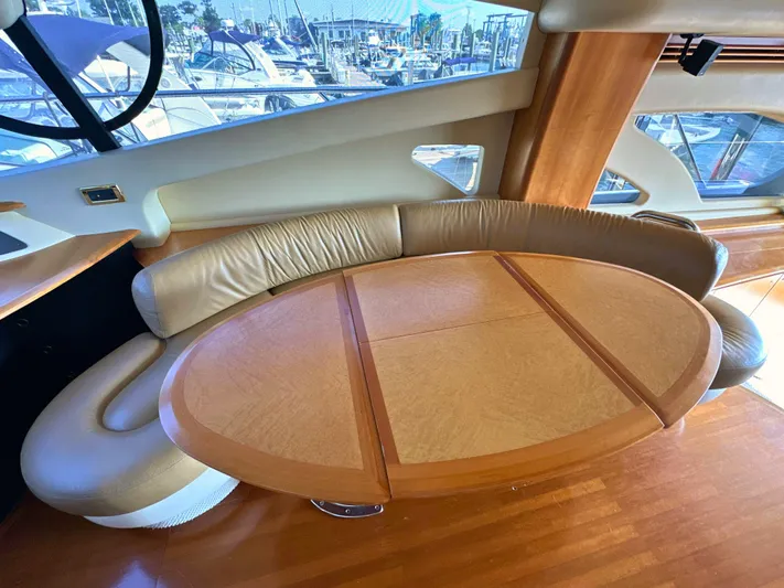 Andiamo Yacht Photos Pics Luxurious interior of 2010 Azimut 55E yacht with elegant wooden table and leather seating.