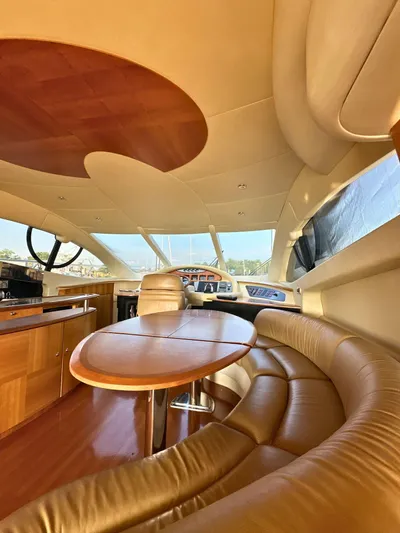 Andiamo Yacht Photos Pics Luxurious interior of a 2010 Azimut 55E yacht with elegant leather seating and wooden finishes.