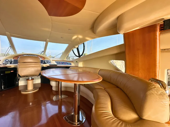 Andiamo Yacht Photos Pics Luxurious interior of a 2010 Azimut 55E yacht with leather seating and wooden accents.
