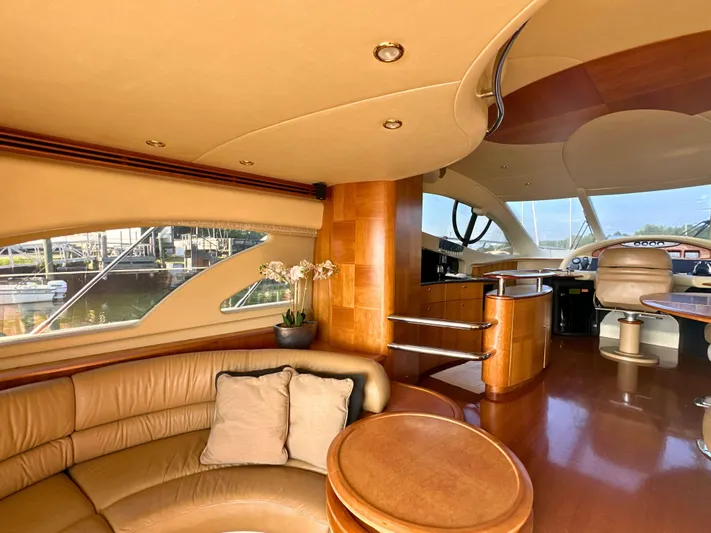 Andiamo Yacht Photos Pics Luxurious interior of a 2010 Azimut 55E yacht with elegant wood finishes and plush seating.