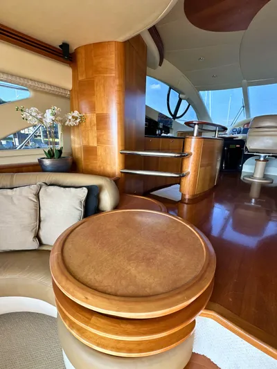 Andiamo Yacht Photos Pics Luxurious interior of a 2010 Azimut 55E yacht with elegant wood finishes and plush seating.
