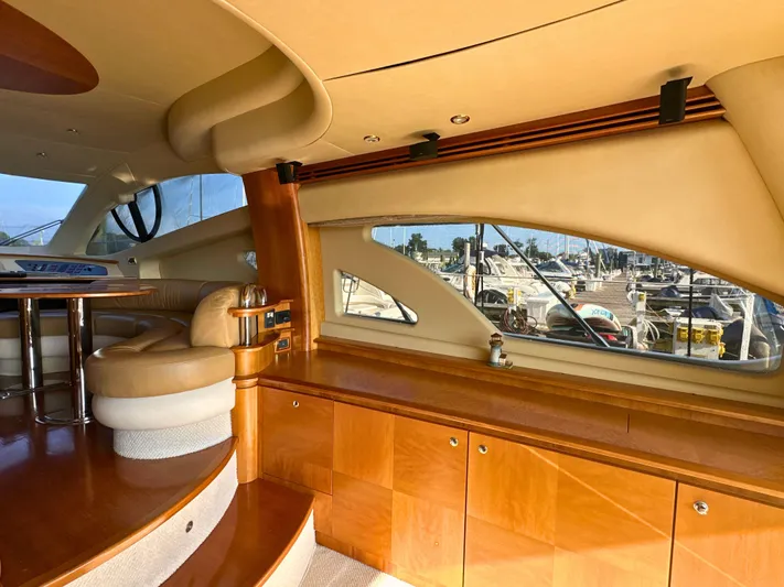 Andiamo Yacht Photos Pics Luxurious interior of 2010 Azimut 55E yacht with elegant wood finishes and marina view.