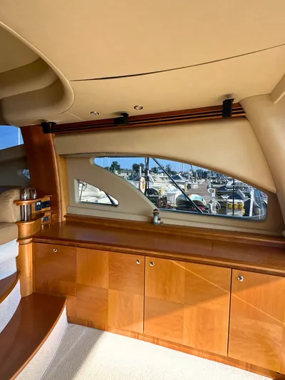 Andiamo Yacht Photos Pics Luxurious interior of a 2010 Azimut 55E yacht with wooden cabinetry and marina view.