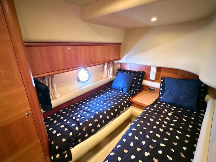 Andiamo Yacht Photos Pics Luxurious cabin interior of 2010 Azimut 55E yacht with twin beds and wooden accents.