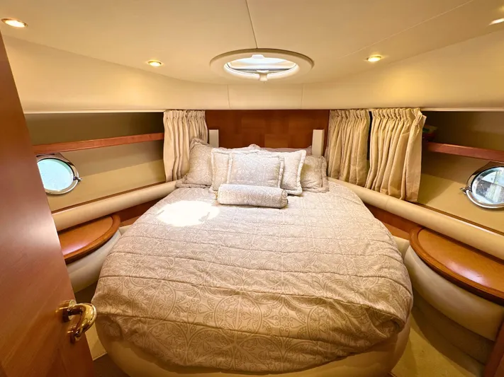Andiamo Yacht Photos Pics Luxurious bedroom interior of 2010 Azimut 55E yacht with elegant bedding and porthole windows.