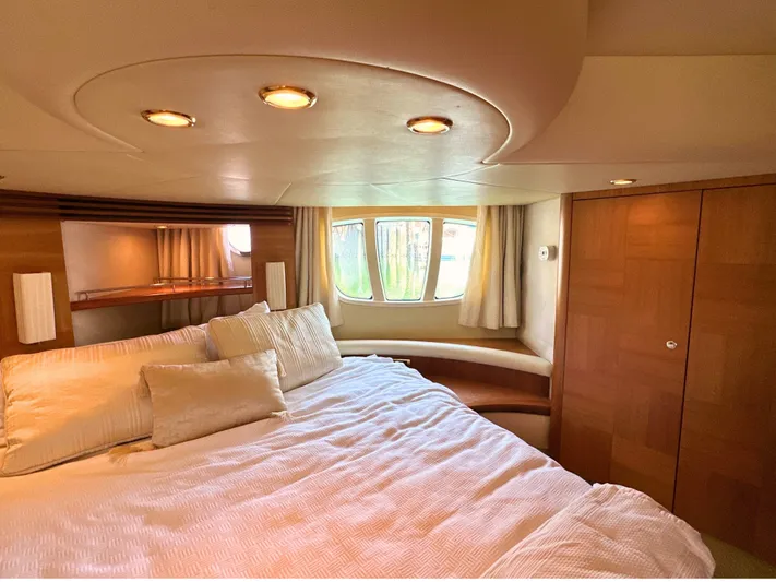 Andiamo Yacht Photos Pics Luxurious bedroom interior of 2010 Azimut 55E yacht with elegant wood finishes.