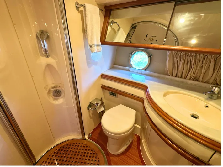 Andiamo Yacht Photos Pics Luxurious bathroom in 2010 Azimut 55E yacht with shower, sink, and porthole window.