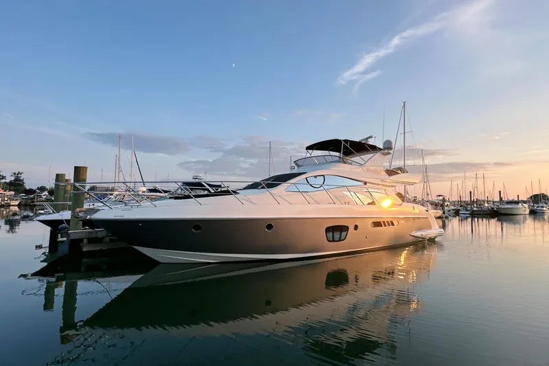 Andiamo Yacht Photos Pics Luxury 2010 Azimut 55E yacht docked at sunset in a serene marina.