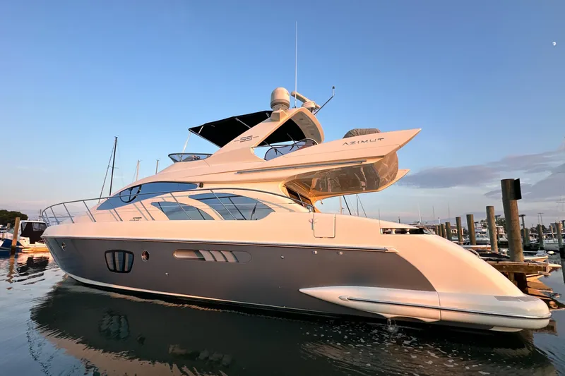 Andiamo Yacht Photos Pics Luxury 2010 Azimut 55E yacht docked at sunset, showcasing sleek design and elegance.