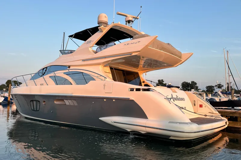 Andiamo Yacht Photos Pics Luxurious 2010 Azimut 55E yacht docked at marina during sunset.