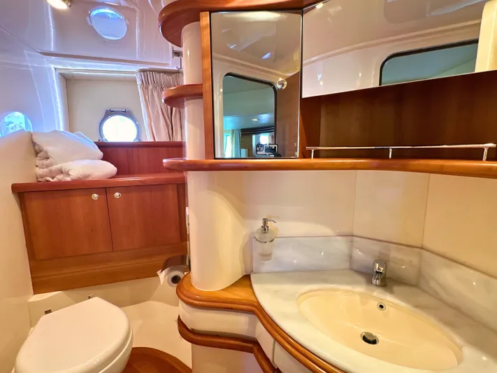 Andiamo Yacht Photos Pics Luxurious bathroom in 2010 Azimut 55E yacht with wooden cabinetry and modern fixtures.