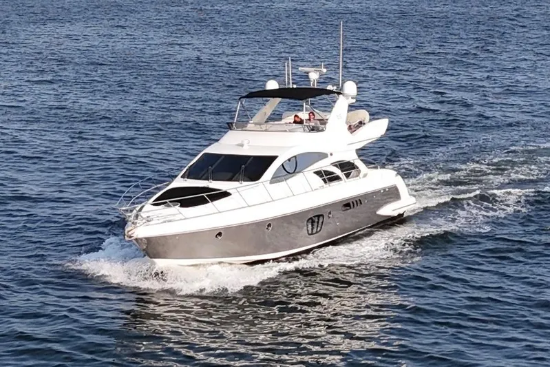 Andiamo Yacht Photos Pics Luxury 2010 Azimut 55E yacht cruising on open water.