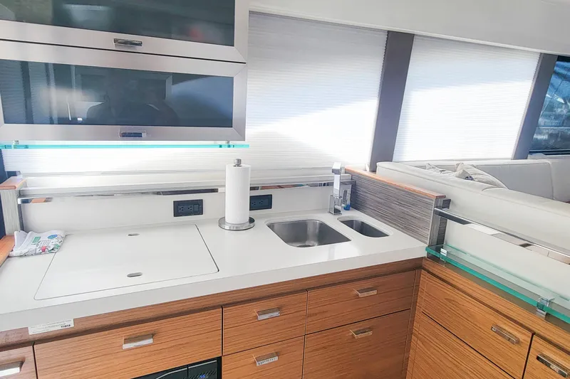 Courageous Yacht Photos Pics Modern kitchen interior of 2020 Tiara Yachts C53 Coupe with sleek cabinetry and dual sinks.