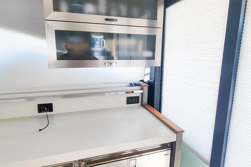 Courageous Yacht Photos Pics Modern kitchen interior of 2020 Tiara Yachts C53 Coupe with sleek cabinetry and appliances.