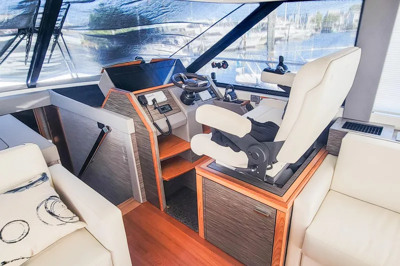Courageous Yacht Photos Pics 2020 Tiara Yachts C53 Coupe helm with luxurious seating and modern controls.