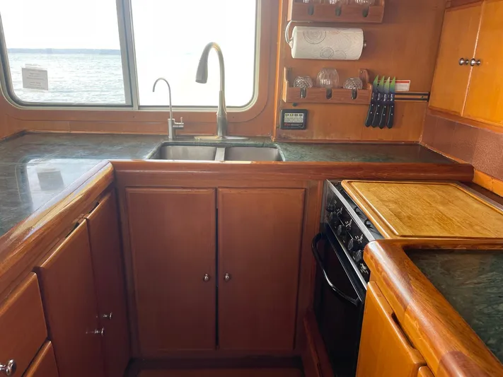Sojourner Yacht Photos Pics Kitchen area of 2002 Transpacific Marine EAGLE 53 yacht with wooden cabinetry and ocean view.