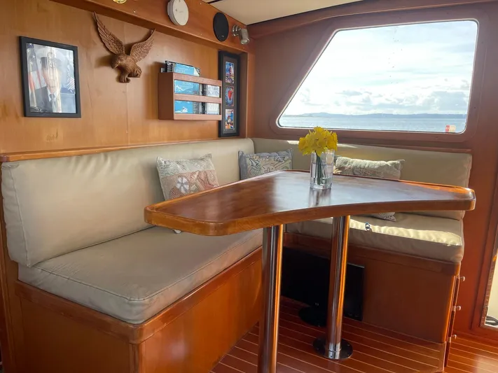 Sojourner Yacht Photos Pics Cozy interior of 2002 Transpacific Marine EAGLE 53 with wooden table and seating.