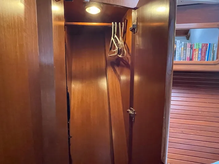 Sojourner Yacht Photos Pics Wooden closet interior with hangers, aboard 2002 Transpacific Marine EAGLE 53 yacht.