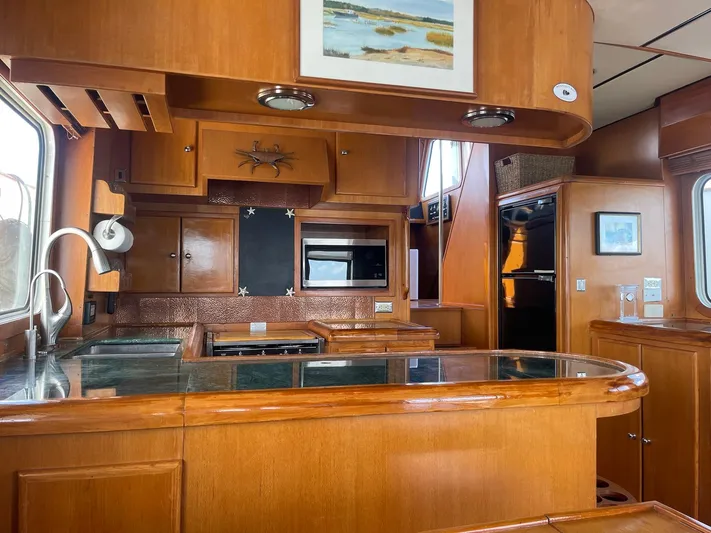 Sojourner Yacht Photos Pics Luxurious wooden kitchen interior of 2002 Transpacific Marine EAGLE 53 yacht.