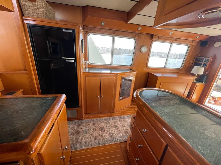 Sojourner Yacht Photos Pics Interior of 2002 Transpacific Marine EAGLE 53 yacht with wooden cabinetry and large windows.
