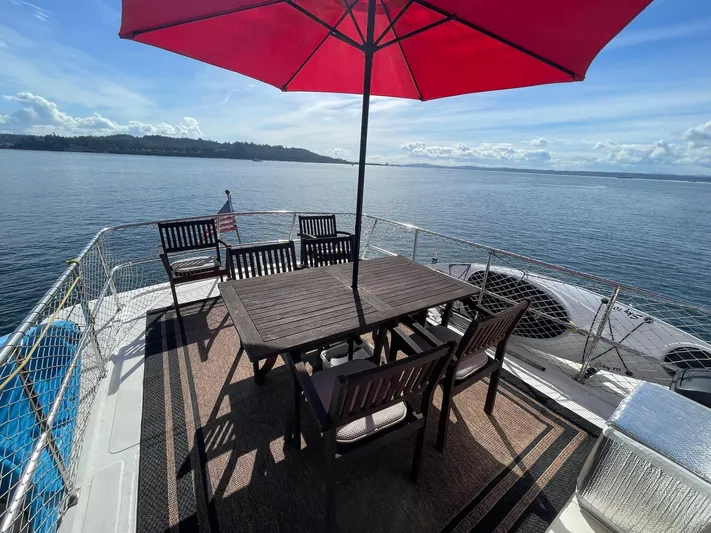 Sojourner Yacht Photos Pics Deck of 2002 Transpacific Marine EAGLE 53 yacht with dining set and red umbrella.
