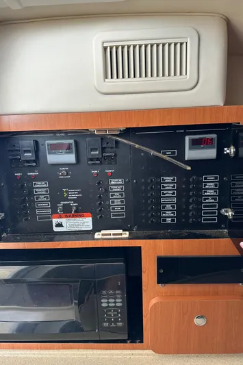  Yacht Photos Pics Control panel and microwave inside a 2005 Hydra-Sports 33VX boat cabin.