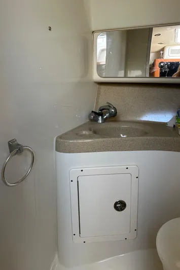 Yacht Photos Pics 2005 Hydra-Sports 33VX boat bathroom with sink, mirror, and storage compartment.