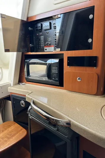  Yacht Photos Pics 2005 Hydra-Sports 33VX interior with microwave, control panel, and countertop.