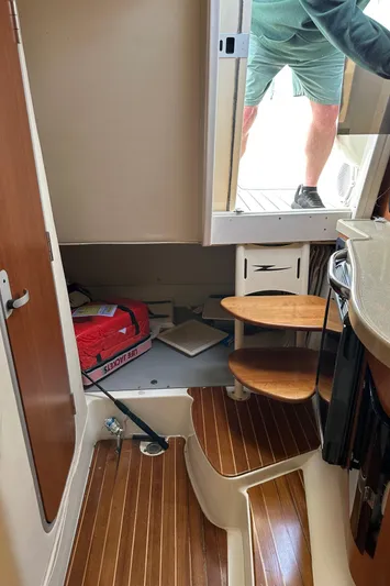  Yacht Photos Pics Interior view of 2005 Hydra-Sports 33VX boat with wooden steps and storage area.