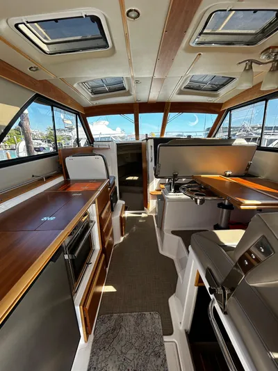 Blue Gail Yacht Photos Pics 2020 Cutwater C-30 Sedan interior with modern kitchen and seating area.