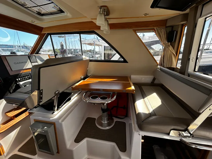 Blue Gail Yacht Photos Pics 2020 Cutwater C-30 Sedan interior with seating, table, and navigation equipment.
