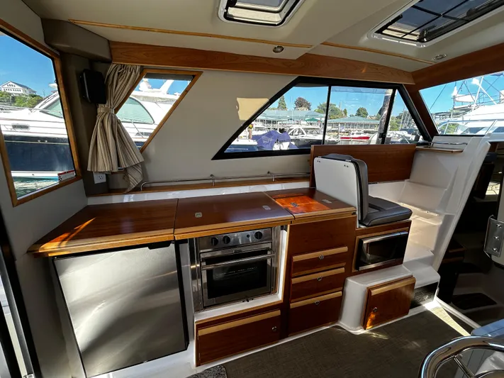 Blue Gail Yacht Photos Pics Interior of 2020 Cutwater C-30 Sedan with modern kitchen and seating area.