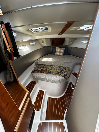 Blue Gail Yacht Photos Pics 2020 Cutwater C-30 Sedan cabin interior with bed, wood accents, and skylights.