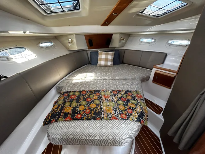 Blue Gail Yacht Photos Pics 2020 Cutwater C-30 Sedan cabin interior with cozy bed and decorative pillows.