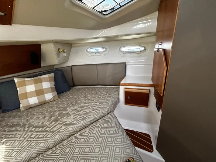 Blue Gail Yacht Photos Pics Cozy interior cabin of 2020 Cutwater C-30 Sedan with bed and portholes.