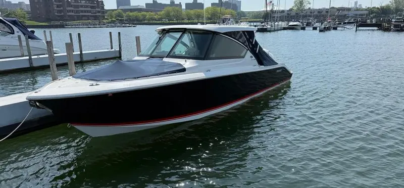  Yacht Photos Pics 2022 Pursuit DC 295 Dual Console boat docked in a marina.