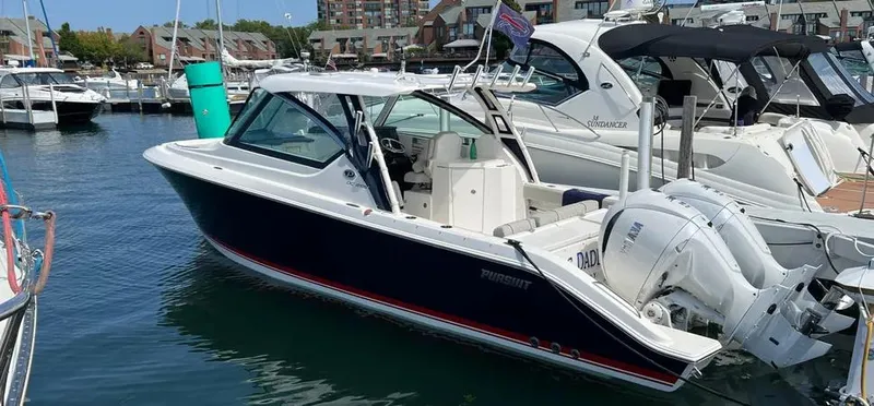  Yacht Photos Pics 2022 Pursuit DC 295 Dual Console boat docked in a marina.