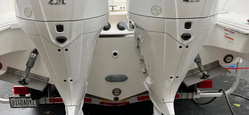  Yacht Photos Pics 2022 Pursuit DC 295 Dual Console with twin outboard engines, rear view.