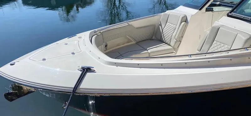  Yacht Photos Pics 2022 Pursuit DC 295 Dual Console boat with elegant seating, docked on calm water.