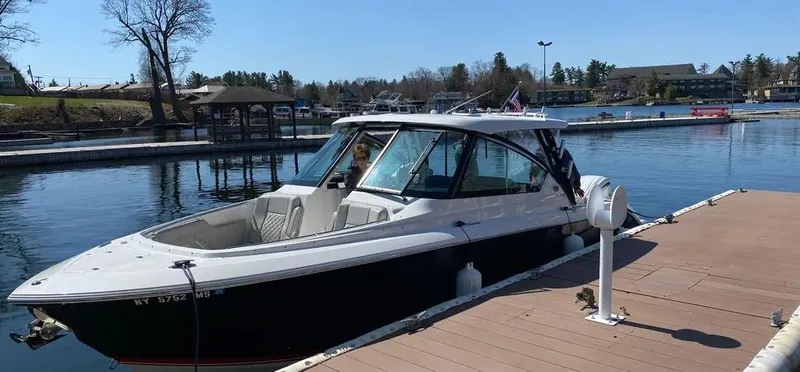  Yacht Photos Pics 2022 Pursuit DC 295 Dual Console boat docked at a marina.