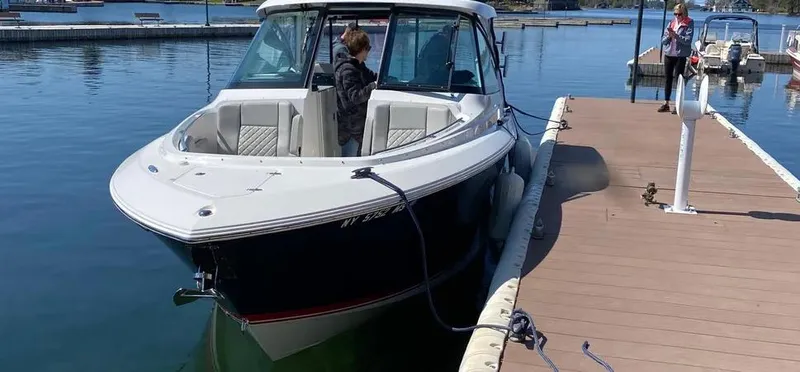 Yacht Photos Pics 2022 Pursuit DC 295 Dual Console boat docked at a marina.