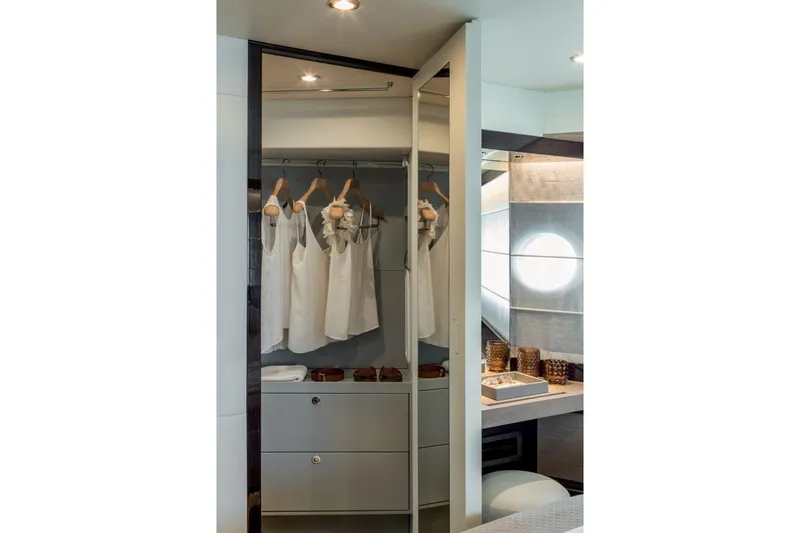  Yacht Photos Pics Luxurious closet interior on Absolute NAVETTA 50 yacht, 2026 model, with elegant clothing display.
