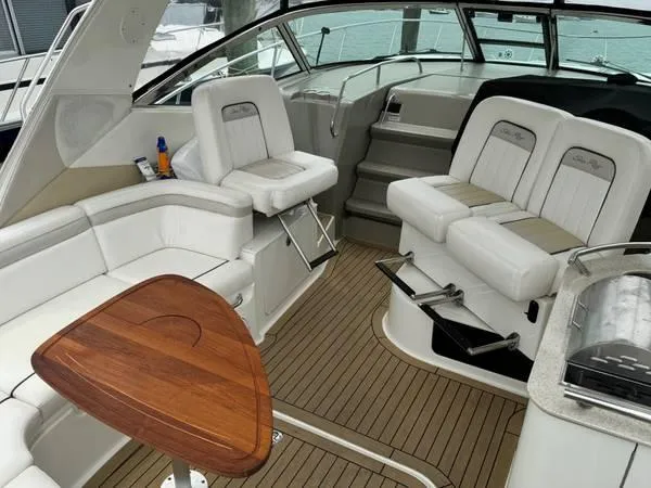  Yacht Photos Pics 2010 Sea Ray 370 Sundancer interior with white seating and wooden table.