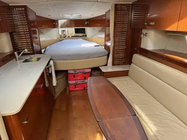  Yacht Photos Pics Interior of 2010 Sea Ray 370 Sundancer yacht with bed, kitchenette, and seating area.