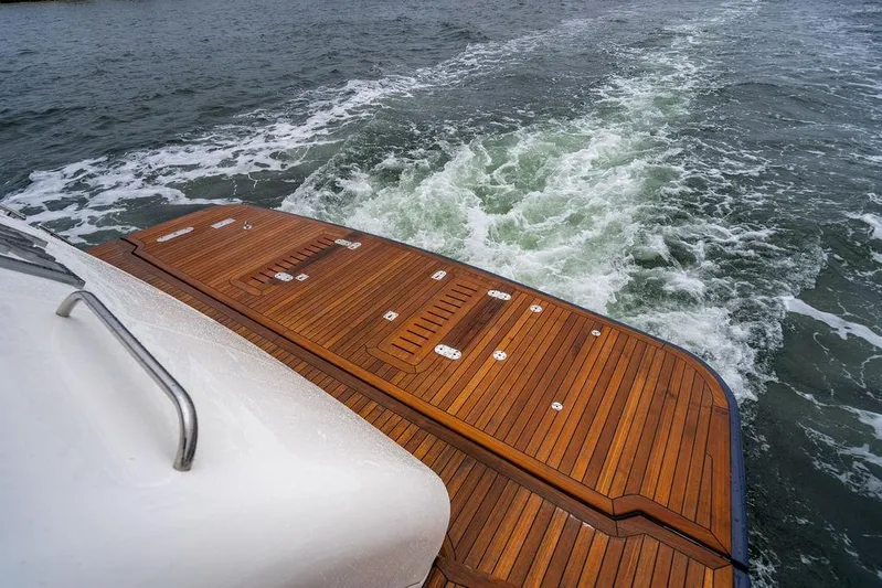  Yacht Photos Pics Sleek teak deck of 2012 Princess Flybridge 72 Motor Yacht cruising on water.