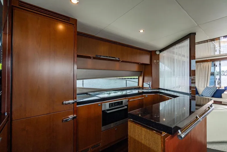  Yacht Photos Pics Luxurious kitchen interior of 2012 Princess Flybridge 72 Motor Yacht with wood cabinetry.