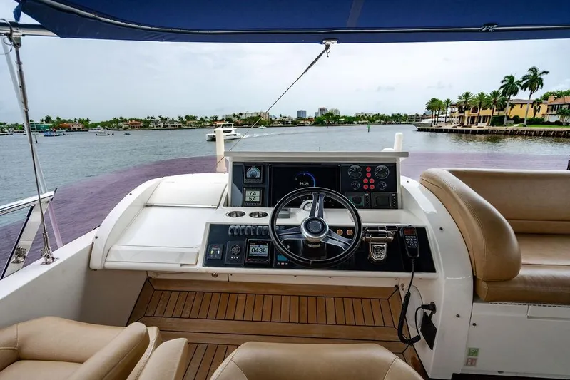  Yacht Photos Pics Flybridge helm of 2012 Princess Flybridge 72 Motor Yacht with scenic waterfront view.