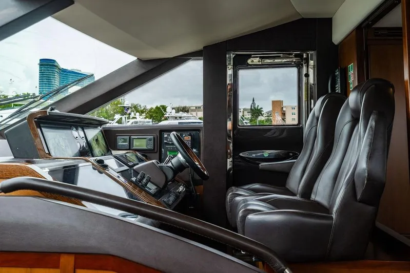  Yacht Photos Pics Luxurious interior of 2012 Princess Flybridge 72 Motor Yacht cockpit with leather seats and control panel.